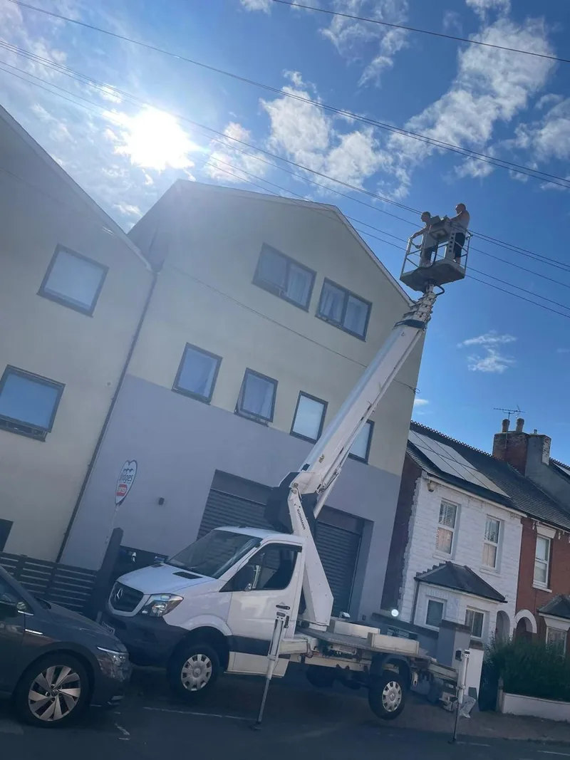 Cherry picker access platform in use for high-level roof works